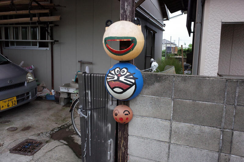 Floating devices used for fishing, one painted like Doraemon