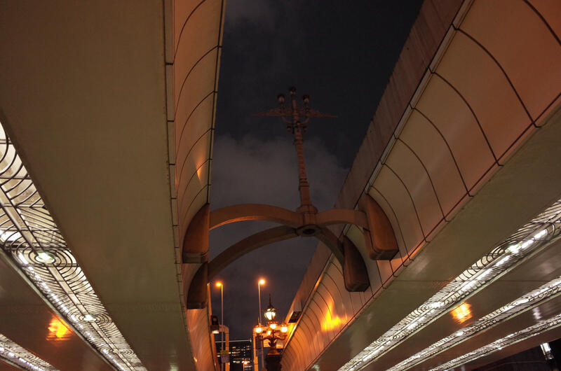 A futuristic looking lamppost suspended between two bridges