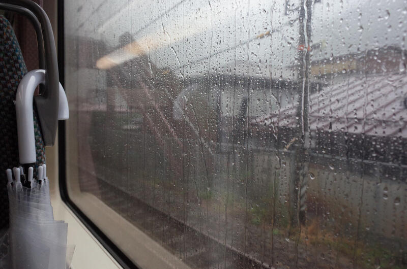 A train window with rain drops on it