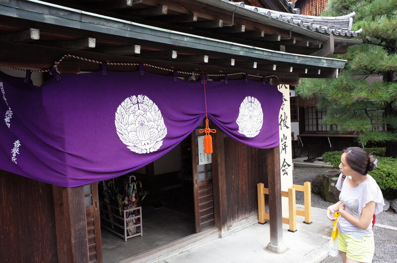 The entrance to a temple building with purple curtains