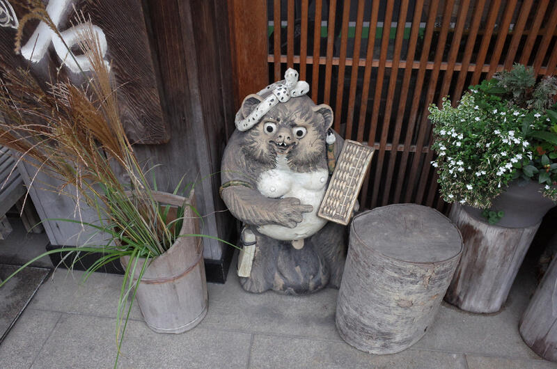 A tanuki statue standing near a doorway