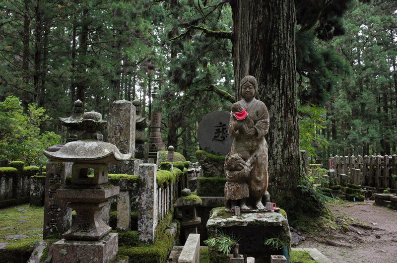 Graves and a statue at Okunoin Cemetary
