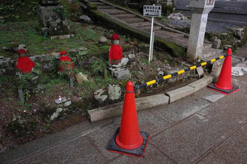 Some Jizō statues and two red cones